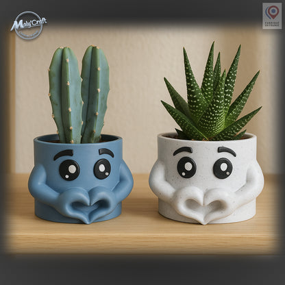 3D printed decorative flower pot in blue with expressive cartoon eyes and arms forming a heart. A modern and original design, perfect to add a touch of fun and tenderness to home decor. Made in France, ideal for holding green plants or cacti and for offering as a unique and symbolic gift.