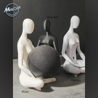 Support Alexa Echo Dot en forme de silhouette assise en méditation, imprimé en 3D en PLA blanc, tenant l’enceinte connectée noire sur fond gris clair, création originale Maly’Craft.