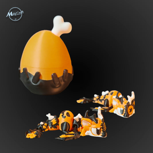 Œuf surprise orange et noir en forme de pilon, contenant un dragon articulé Halloween imprimé en 3D.